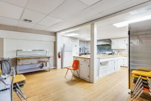 Bundick Lake RV Park Bundick Lake Retreat and RV Park kitchen in DeRidder, LA with white cabinets, large sink, stove, fridge, bright lighting.