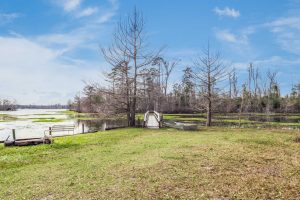 Bundick Lake RV Park Bundick Lake Retreat and RV Park in DeRidder Louisiana features a wooden bridge over water, green grass, trees, and scenic lake views.